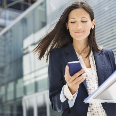 Businesswoman using cell phone in office
